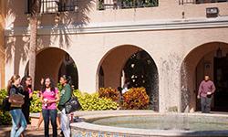 Students walking by the fountain in the Horseshoe on the Gulfport campus